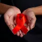 Men holding red ribbons. Conceptual awareness. Hiv. World aids day and world sexual health day.